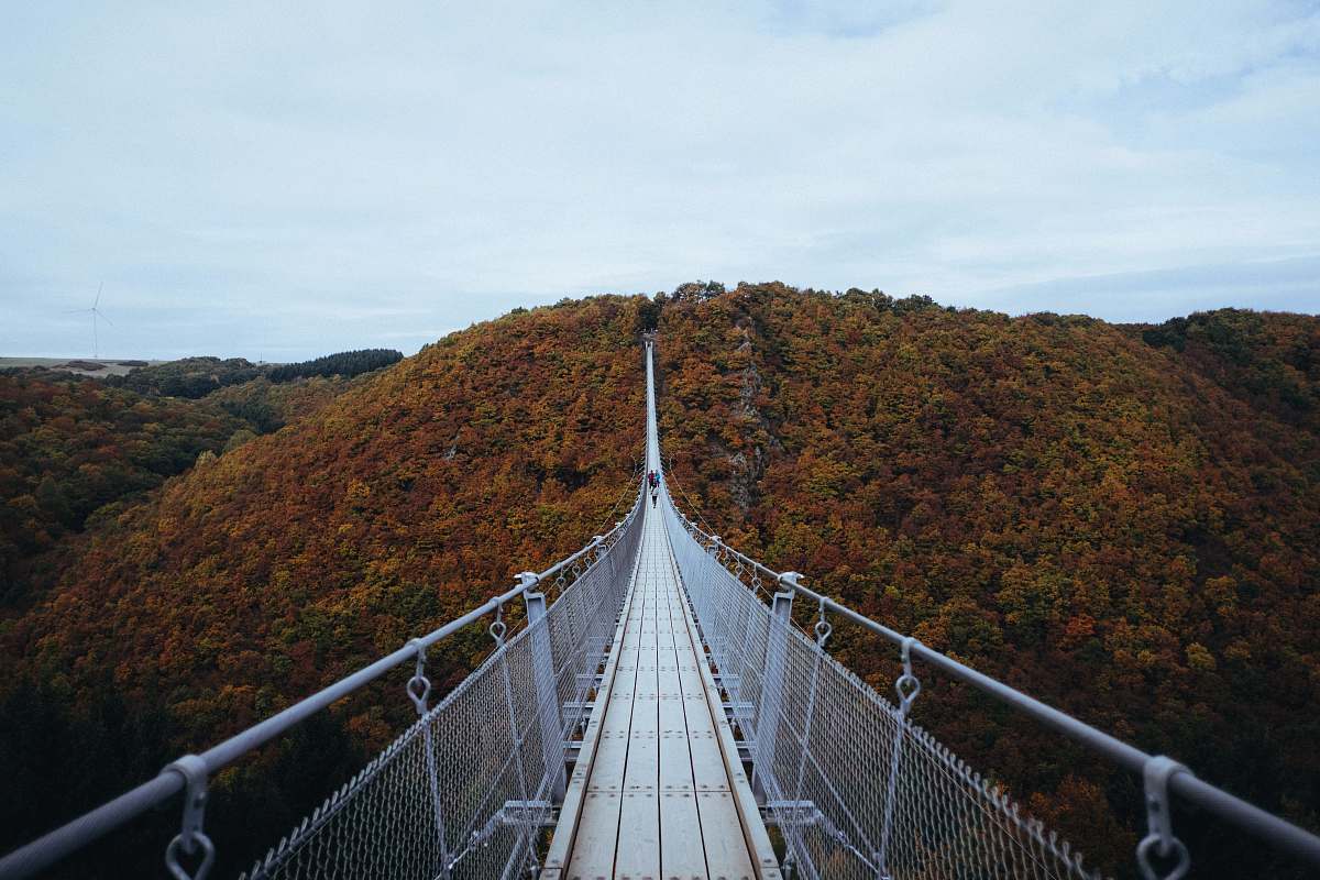bridge person walking on white hanging bridge during daytime desktop wallpapers